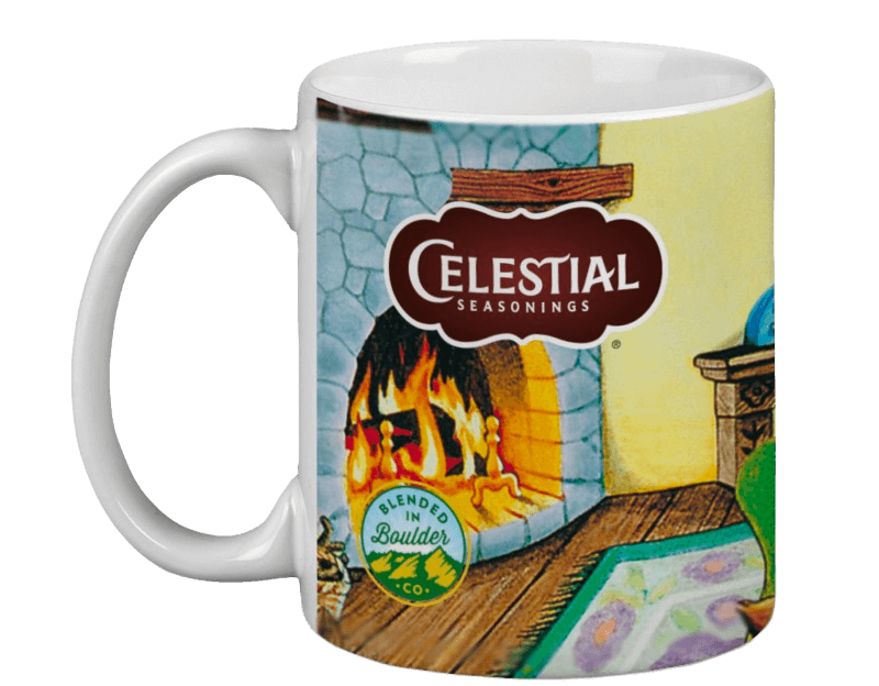 Ceramic mug featuring a cozy fireplace illustration with a warm flame, "Celestial Seasonings" logo, and "Blended in Boulder, CO" emblem, evoking warmth.
